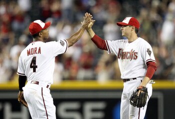 PHOENIX, AZ - MAY 30:   Kelly Johnson #2 of the Arizona Diamondbacks high fives teammate Melvin Mora #4 after defeating the Florida Marlins in the Major League Baseball game at Chase Field on May 30, 2011 in Phoenix, Arizona. The Diamondbacks defeated the