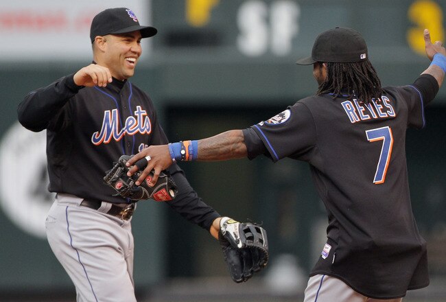 DENVER, CO - MAY 12:  Carlos Beltran #15 and Jose Reyes #7 of the New York Mets celebrate their 9-5 victory over the Colorado Rockies at Coors Field on May 12, 2011 in Denver, Colorado.  (Photo by Doug Pensinger/Getty Images)