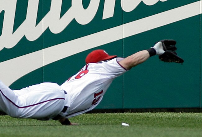 WASHINGTON, DC - JUNE 01: Left fielder Laynce Nix #19 of the Washington Nationals catches a ball hit by  Domonic Brown #9 of the Philadelphia Phillies (not pictured) for the third out of the sixth inning at Nationals Park on June 1, 2011 in Washington, DC