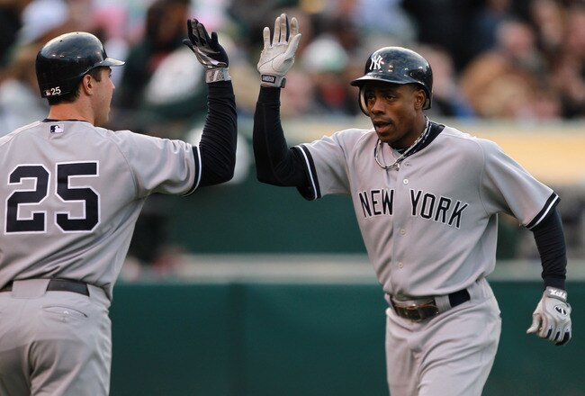 OAKLAND, CA - MAY 31:  Curtis Granderson #14 of the New York Yankees is congratulated by Mark Teixeira #25 of the New York Yankees after he hit a two run home run in the first inning against the Oakland Athletics at Oakland-Alameda County Coliseum on May