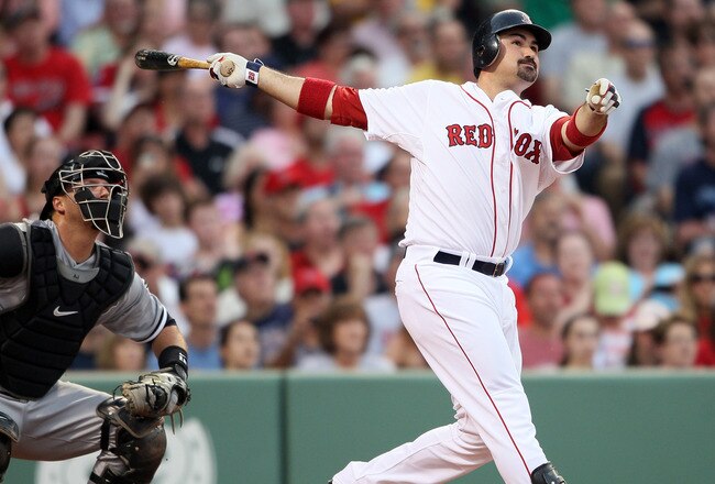 BOSTON, MA - MAY 30:  Adrian Gonzalez #28 of the Boston Red Sox hits a solo home run in the first inning as A.J. Pierzynski #12 of the Chicago White Sox catches on May 30, 2011 at Fenway Park in Boston, Massachusetts.  (Photo by Elsa/Getty Images)
