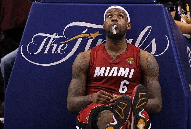 DALLAS, TX - JUNE 05:  LeBron James #6 of the Miami Heat sits on the court as court attendants mop up liquid which was spilt onto the court agaisnt the Dallas Mavericks in the second half of Game Three of the 2011 NBA Finals at American Airlines Center on