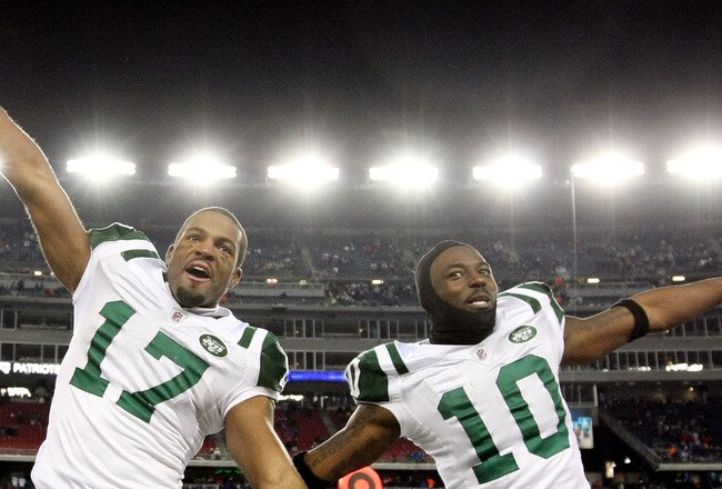 FOXBORO, MA - JANUARY 16:  Braylon Edwards #17 and Santonio Holmes #10 of the New York Jets celebrate on their way to defeating the New England Patriots 28 to 21 victory over the New England Patriots during their 2011 AFC divisional playoff game at Gillet