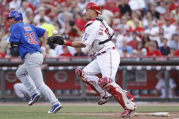 CINCINNATI, OH - JUNE 7: Ramon Hernandez #55 of the Cincinnati Reds fields a bunt by Doug Davis #32 of the Chicago Cubs at Great American Ball Park on June 7, 2011 in Cincinnati, Ohio. (Photo by Joe Robbins/Getty Images)