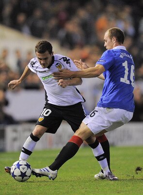 VALENCIA, SPAIN - NOVEMBER 02:  Juan Mata of Valencia CF (L) Steven Whittaker of Glasgow Rangers duel for a ball during their UEFA Champions League group C match between Valencia CF and Glasgow Rangers at the Mestalla Stadium on November 2, 2010 in Valenc