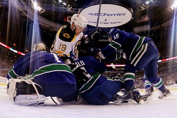 VANCOUVER, BC - JUNE 10:  Tyler Seguin #19 of the Boston Bruins collides with Roberto Luongo #1, Sami Salo #6 and Maxim Lapierre #40 of the Vancouver Canucks during Game Five of the 2011 NHL Stanley Cup Final at Rogers Arena on June 10, 2011 in Vancouver,