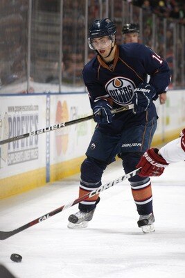 EDMONTON, CANADA - MARCH 17: Jordan Eberle #14 of the Edmonton Oilers fights for the puck against the Phoenix Coyotes on March 17, 2011 at Rexall Place in Edmonton, Alberta, Canada. (Photo by Dale MacMillan/Getty Images)
