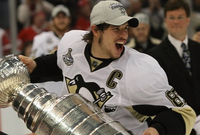 DETROIT - JUNE 12: Sidney Crosby #87 of the Pittsburgh Penguins holds the Stanley Cup following the Penguins victory over the Detroit Red Wings in Game Seven of the 2009 NHL Stanley Cup Finals at Joe Louis Arena on June 12, 2009 in Detroit, Michigan.  (Ph