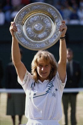 Steffi Graf of Germany holds aloft the Venus Rosewater Dish after defeating Martina Navratilova 57, 62, 61in their Women's Singles Final match at the Wimbledon Lawn Tennis Championship on 3rd July 1988 at the All England Lawn Tennis and Croquet Club in