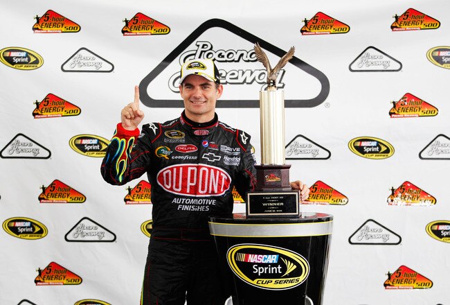 LONG POND, PA - JUNE 12:  Jeff Gordon, driver of the #24 DuPont Chevrolet, celebrates with the trophy after winning the NASCAR Sprint Cup Series 5-Hour Energy 500 at Pocono Raceway on June 12, 2011 in Long Pond, Pennsylvania.  (Photo by Geoff Burke/Getty 