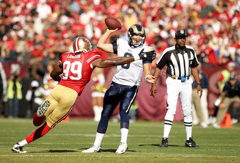 SAN FRANCISCO - NOVEMBER 14:  Sam Bradford #8  of the St. Louis Rams is hit by Manny Lawson #99 of the San Francisco 49ers at Candlestick Park on November 14, 2010 in San Francisco, California.  (Photo by Ezra Shaw/Getty Images)