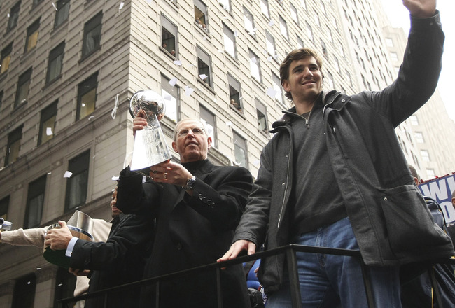 NEW YORK - FEBRUARY 05:  New York Giants coach Tom Coughlin (L) and quarterback Eli Manning wave to fans during the New York Giants Superbowl XLII victory parade February 5, 2008 in New York City.  (Photo by Chris McGrath/Getty Images)