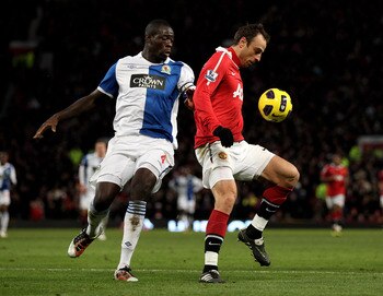 MANCHESTER, ENGLAND - NOVEMBER 27:  Dimitar Berbatov of Manchester United competes with Chris Samba of Blackburn Rovers during the Barclays Premier League match between Manchester United and Blackburn Rovers at Old Trafford on November 27, 2010 in Manches