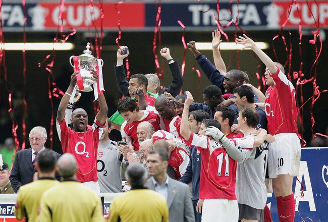 CARDIFF, UNITED KINGDOM - MAY 21: Arsenal captain, Patrick Vieira, holds the trophy aloft as team mates celebrate after winning the FA Cup Final between Arsenal and Manchester United 5-4 on penalty's at The Millennium Stadium on May 21, 2005 in Cardiff, W