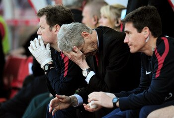 STOKE ON TRENT, ENGLAND - MAY 08:  A dejected Arsene Wenger the Arsenal manager holds his head in his hands as his team head towards a 3-1 defeat during the Barclays Premier League match between Stoke City and Arsenal at the Britannia Stadium on May 8, 20