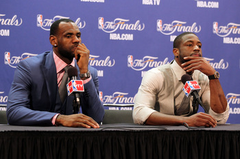 MIAMI, FL - JUNE 12:  (L-R) LeBron James #6 and Dwyane Wade #3 of the Miami Heat answer questions from the media at a post game news conference after the Dallas Mavericks won 105-95 in Game Six of the 2011 NBA Finals at American Airlines Arena on June 12,