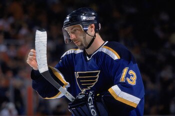 DETROIT - APRIL 14:  Center Ray Ferraro #13 of the St. Louis Blues examines his hockey stick, during the NHL game against the Detroit Red Wings at the Joe Louis Arena in Detroit, Michigan. The Blues won, 5-3.  \ (Photo by Tom Pidgeon/Getty Images/NHLI)
