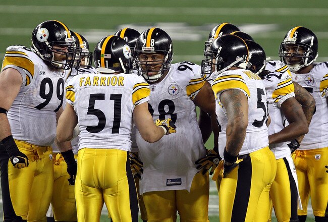 ARLINGTON, TX - FEBRUARY 06:  James Farrior #51 of the Pittsburgh Steelers calls a play in the defensive huddle as Brett Keisel #99 and Casey Hampton #98 (c) look on against the Green Bay Packers during Super Bowl XLV at Cowboys Stadium on February 6, 201
