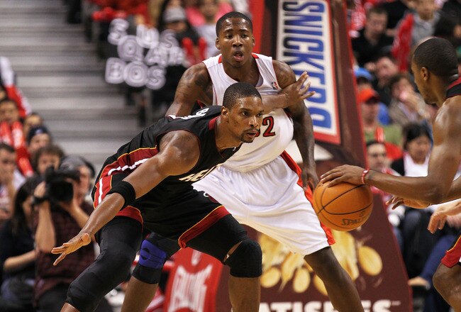TORONTO, CAN - FEBRUARY 16:  Chris Bosh #1 of the Miami Heat plays a block against Ed Davis #32 of the Toronto Raptors in a game on February 16, 2011 at the Air Canada Centre in Toronto, Canada. The Heat defeated the Raptors 103-95. (Photo by Claus Anders