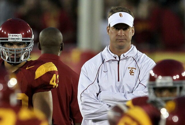 LOS ANGELES - SEPTEMBER 11:  Head coach Lane Kiffin watches the USC Trojans warm up for their game with the Virginia Cavaliers at Los Angeles Memorial Coliseum on September 11, 2010 in Los Angeles, California. (Photo by Stephen Dunn/Getty Images)