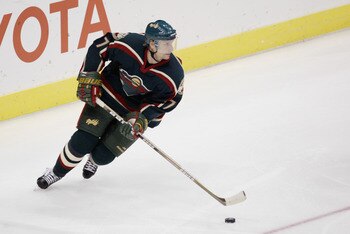 LOS ANGELES - NOVEMBER 4:  Defenseman Lubomir Sekeras #77 of the Minnesota Wild skates the puck out of their zone during the NHL game against the Los Angeles Kings on November 4, 2002 at Staples Center in Los Angeles, California.  The Wild won 5-2. (Photo