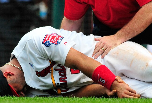 ST. LOUIS, MO - JUNE 19: Albert Pujols #5 of the St. Louis Cardinals holds his wrist after a collision with Wilson Betemit #24 of the Kansas City Royals at Busch Stadium on June 19, 2011 in St. Louis, Missouri.  (Photo by Jeff Curry/Getty Images)