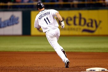 ST. PETERSBURG, FL - JUNE 16:  Infielder Casey Kotchman #11 of the Tampa Bay Rays rounds the bases after his sixth inning home run against the Boston Red Sox during the game at Tropicana Field on June 16, 2011 in St. Petersburg, Florida.  (Photo by J. Mer