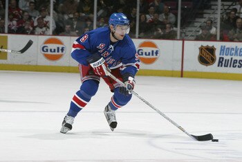 EAST RUTHERFORD, NJ - NOVEMBER 21:  Right wing Pavel Bure #9 of the New York Rangers skates with the puck against the New Jersey Devils during the NHL game at the Continental Airlines Arena on November 21, 2002 in East Rutherford, New Jersey.  The game en