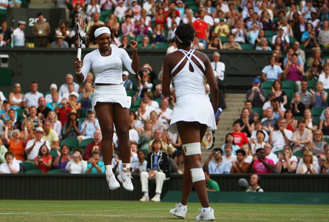 WIMBLEDON, ENGLAND - JULY 04:  Venus Williams of USA (LR and Serena Williams of USA celebrate victory during the women's doubles final match against Samantha Stosur of Australia and Rennae Stubbs of Australia on Day Twelve of the Wimbledon Lawn Tennis Cha