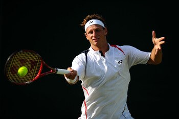 LONDON, ENGLAND - JUNE 21:  David Nalbandian of Argentina returns a shot during his first round match against Julian Reister of Germany on Day Two of the Wimbledon Lawn Tennis Championships at the All England Lawn Tennis and Croquet Club on June 21, 2011 