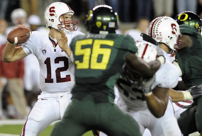 EUGENE, OR - OCTOBER 2: Quarterback Andrew Luck #12 of the Stanford Cardinal sets to throw a pass as linebacker Josh Kaddu #56 of the Oregon Ducks applies pressure in the third quarter of the game at Autzen Stadium on October 2, 2010 in Eugene, Oregon. Or