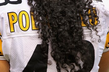 DENVER - AUGUST 29:  The name on the back of the jersey of safety Troy Polamalu #43 of the Pittsburgh Steelers is obscured by his hair as he defends against the Denver Broncos during preseason NFL action at INVESCO Field at Mile High on August 29, 2010 in