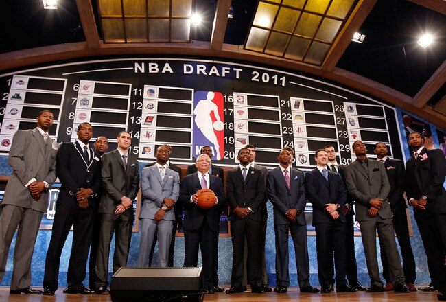 NEWARK, NJ - JUNE 23:  The 2011 Draft class including Kyrie Irving, Derrick Williams, Enes Kanter, Jonas Valanciunas, Brandon Knight, Jimmer Fredette and Kemba Walker pose for a group photo with NBA Commissioner David Stern (C) during the 2011 NBA Draft a