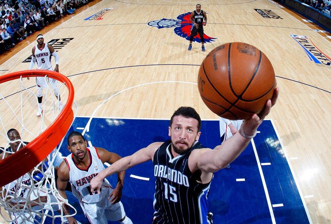 ATLANTA, GA - APRIL 28:  Hedo Turkoglu #15 of the Orlando Magic grabs a rebound against Al Horford #15 of the Atlanta Hawks during Game Six of the Eastern Conference Quarterfinals in the 2011 NBA Playoffs at Philips Arena on April 28, 2011 in Atlanta, Geo