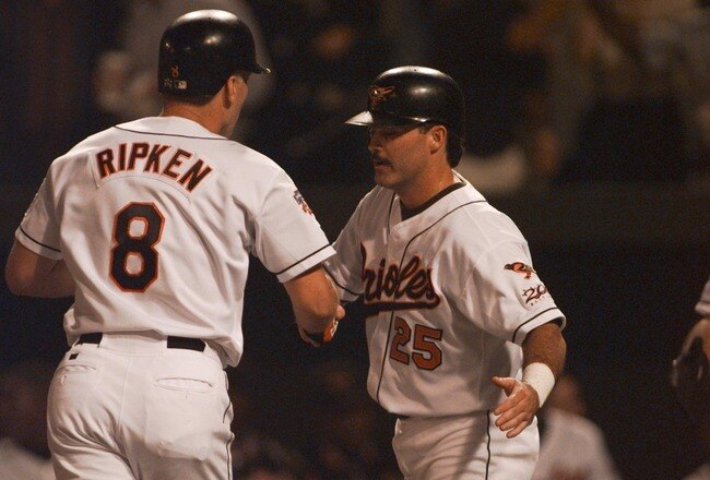 9 Oct 1997: Rafael Palmeiro #25 of the Baltimore Orioles shakes the hand of Cal Ripken Jr. after Ripken hit a two run homerun during the second inning in game two of the American League Championship Series at Camden Yards in Baltimore, Maryland.