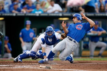 KANSAS CITY, MO - JUNE 25:  Reed Johnson #5 of the Chicago Cubs is tagged out by Matt Treanor #15 of the Kansas City Royals as he tries to score at Kauffman Stadium on June 25, 2011 in Kansas City, Missouri. (Photo by Ed Zurga/Getty Images)