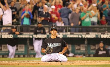 SEATTLE - JUNE 26:  Relief Steve Cishek #66 of the Florida Marlins kneels at home plate after throwing a wild pitch while trying to intentionally walk Carlos Peguero #8 of the Seattle Mariners allowing Dustin Ackley to score from third in the tenth inning