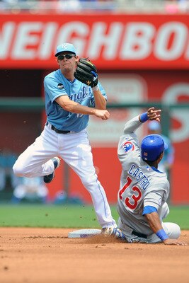 KANSAS CITY, MO - JUNE 26:  Chris Getz #17 of the Kansas City Royals throws to first base to complete a double play in the first inning as Starlin Castro #13 of the Chicago Cubs slides at Kauffman Stadium on June 26, 2011 in Kansas City, Missouri. (Photo