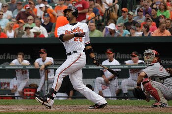 BALTIMORE, MD - JUNE 26: Catcher Ramon Hernandez #55 of the Cincinnati Reds looks on as Derrek Lee #25 of the Baltimore Orioles follows his fourth inning three run home run at Oriole Park at Camden Yards on June 26, 2011 in Baltimore, Maryland.  (Photo by