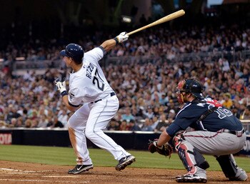 SAN DIEGO, CA - JUNE 24:  Anthony Rizzo #27 of the San Diego Padres hits double as Brian McCann #16 of the Atlanta Braves looks on during the second inning of a baseball game at Petco Park on June 24, 2011 in San Diego, California.  (Photo by Denis Poroy/