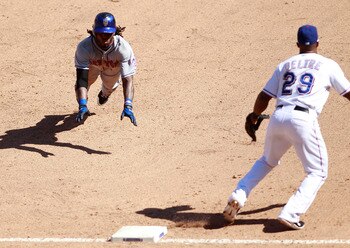 ARLINGTON, TX - JUNE 26: Jose Reyes #7 of the New York Mets dive for third base against the Adrian Beltre #29 of the Texas Rangers at Rangers Ballpark in Arlington on June 26, 2011 in Arlington, Texas.  (Photo by Rick Yeatts/Getty Images)