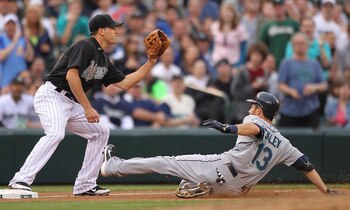 SEATTLE - JUNE 26:  Dustin Ackley #13 of the Seattle Mariners slides into third base on a triple against Greg Dobbs #29 of the Florida Marlins at Safeco Field on June 26, 2011 in Seattle, Washington. (Photo by Otto Greule Jr/Getty Images)