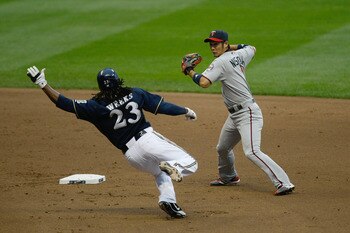 MILWAUKEE, WI - JUNE 24: Tsuyoshi Nishioka #1 of the Minnesota Twins throws the baseball as Rickie Weeks #23 of the Milwaukee Brewers slides at Miller Park on June 24, 2011 in Milwaukee, Wisconsin. (Photo by Scott Boehm/Getty Images)