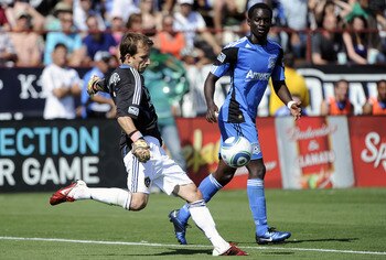 SANTA CLARA, CA - JUNE 25: Mike Magee #18 of the Los Angeles Galaxy has to play goal keeper wearing Josh Saunders #12 jersey after Saunders gets red carded for elbowing Steven Lenhart #24 of the San Jose Earthquakes in the back of his head during an MLS s