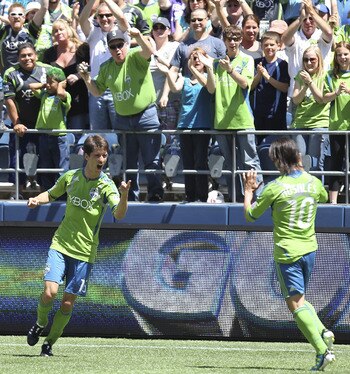 SEATTLE - JUNE 26:  Alvaro Fernandez #15 (L) of the Seattle Sounders FC celebrates with Mauro Rosales #10 after scoring the second goal against the New England Revolution at CenturyLink Field on June 26, 2011 in Seattle, Washington. (Photo by Otto Greule