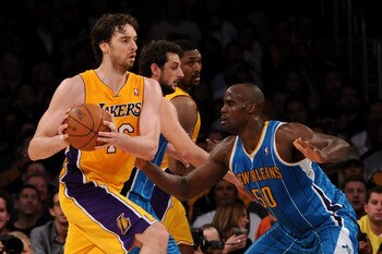LOS ANGELES, CA - APRIL 26:  Pau Gasol #16 of the Los Angeles Lakers with the ball against Emeka Okafor #50 of the New Orleans Hornets in Game Five of the Western Conference Quarterfinals in the 2011 NBA Playoffs on April 26, 2011 at Staples Center in Los