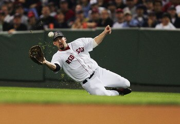 BOSTON - SEPTEMBER 24: Trot Nixon #7 of the Boston Red Sox makes a catch from a hit by Jorge Posada #20 of the New York Yankees during their game on September 24, 2004 at Fenway Park in Boston, Massachusetts.  (Photo by Al Bello/Getty Images)