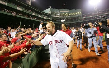 BOSTON - OCTOBER 8: Kevin Millar #15 and Manny Ramirez #24 of the Boston Red Sox celebrate on the field after the American League Division Series with the Anaheim Angels, Game 3 on October 8, 2004 at Fenway Park in Boston, Massachusetts. (Photo by Ezra Sh
