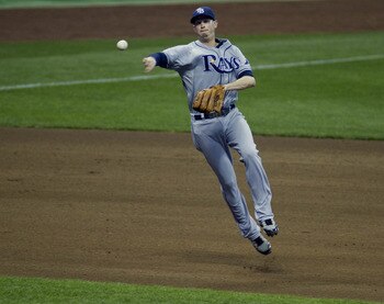 MILWAUKEE, WI - JUNE 21: Reid Brignac #15 of the Tampa Bay Rays throws out Corey Hart #1 of the Milwaukee Brewers at first in the fourth inning of a Major League Baseball game at Miller Park Stadium on June 21, 2011 in Milwaukee, Wisconsin. (Photo by Darr