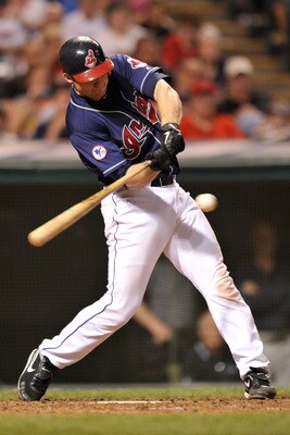 CLEVELAND, OH - JUNE 21:  Lou Marson #6 of the Cleveland Indians connects for a triple against the Colorado Rockies at Progressive Field on June 21, 2011 in Cleveland, Ohio. Colorado defeated Cleveland 4-3.   (Photo by Jamie Sabau/Getty Images)